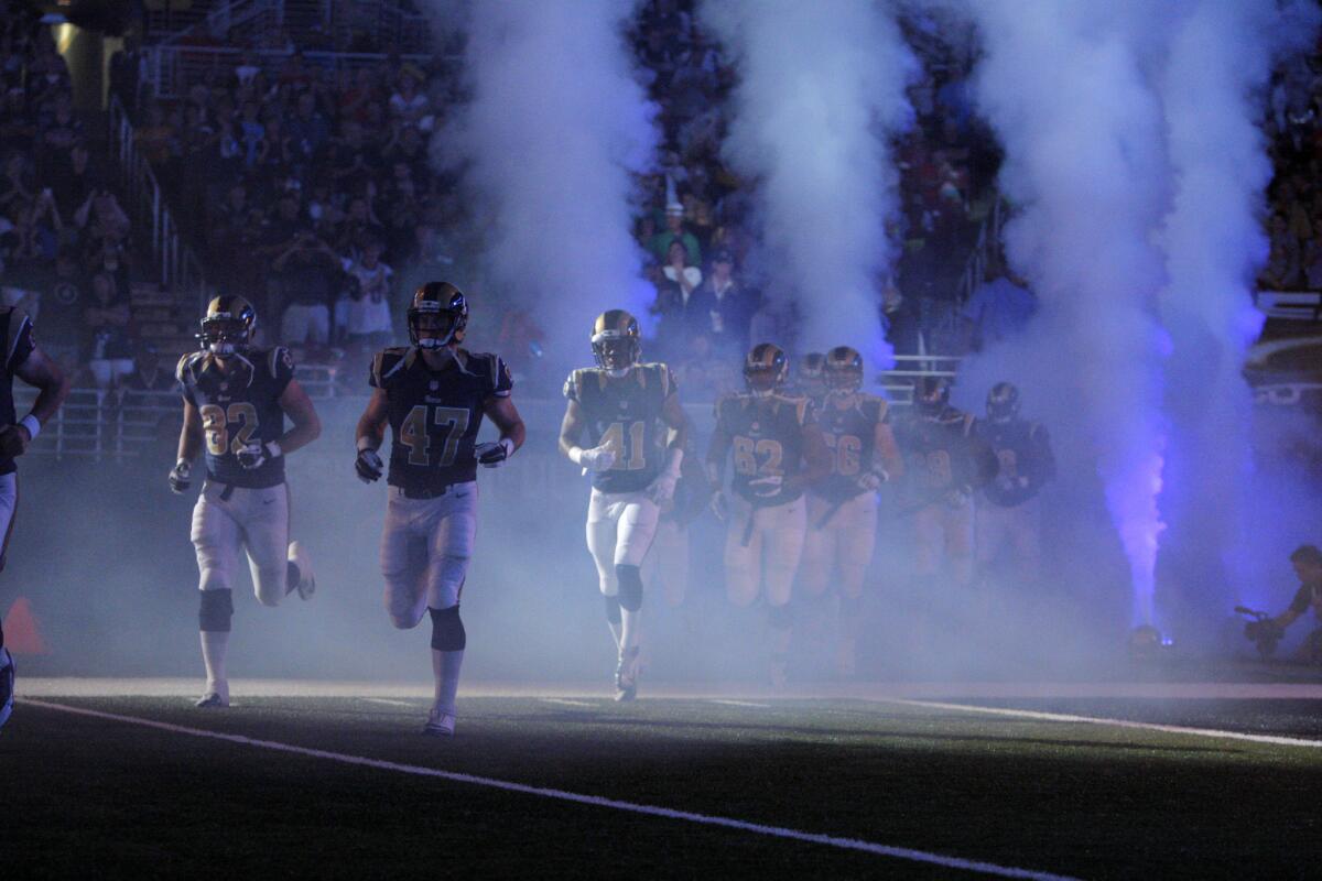 St. Louis Rams players run onto the field before the start of their preseason game against the Green Bay Packers on Saturday at the Edward Jones Dome.