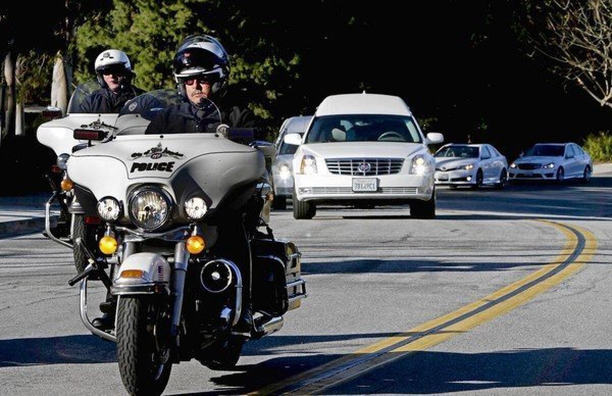 The funeral procession carrying the bodies of Monica Quan and Keith Lawrence, the first two people police believe were killed by Christopher Dorner, leaves Concordia University in Irvine after the memorial on Sunday. The couple met at Concordia University and were engaged.