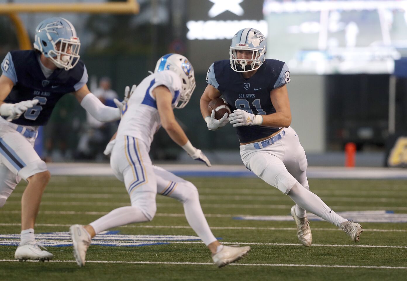 Corona del Mar's Mark Redman, right, carries the ball against Serra during the second half.