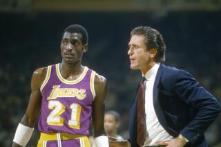UNSPECIFIED - CIRCA 1985: Head Coach Pat Riley of the Los Angeles Lakers talks with Michael Cooper.