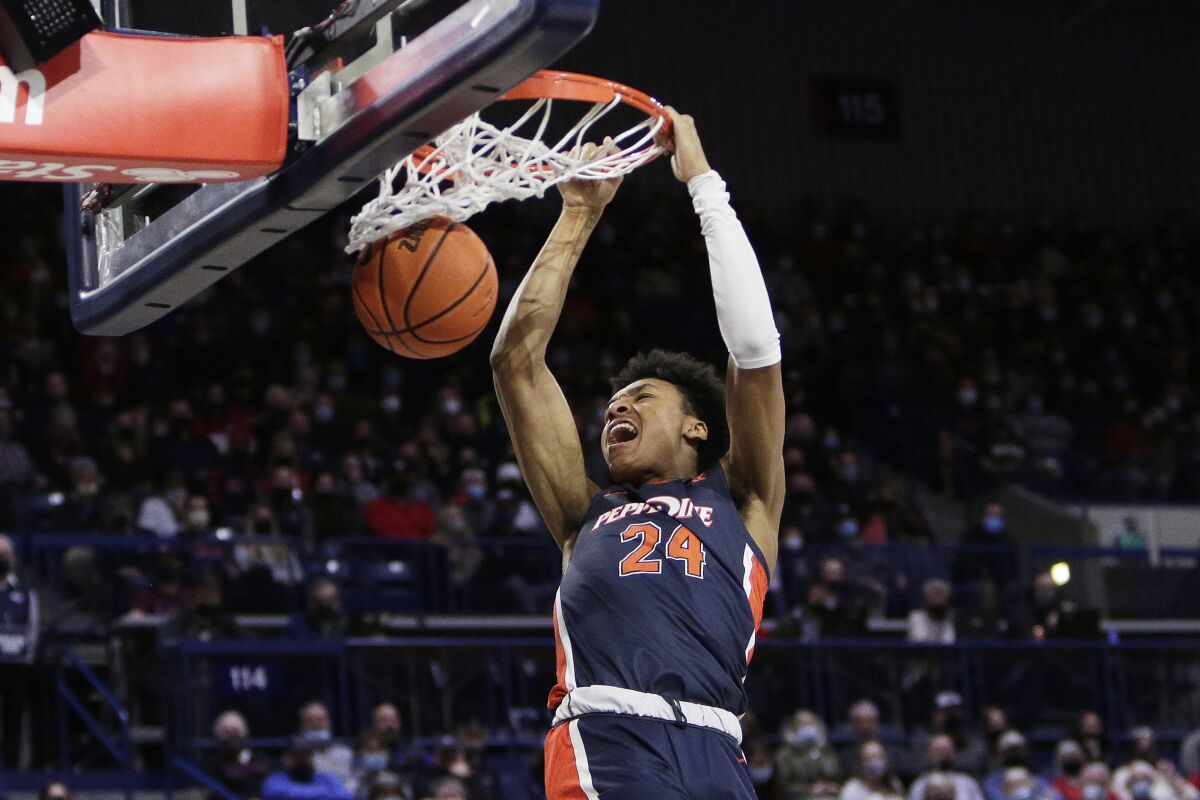 Pepperdine forward Maxwell Lewis dunks during the first half of the team's NCAA college basketball game against Gonzaga, Saturday, Jan. 8, 2022, in Spokane, Wash. (AP Photo/Young Kwak)