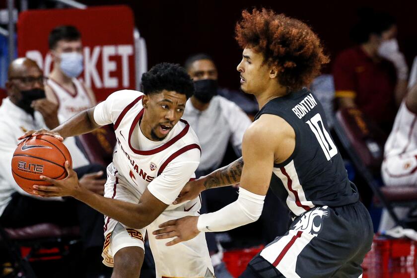 USC guard Tahj Eaddy, left, is defended by Washington State's Isaac Bonton on Jan. 16, 2021, in Los Angeles.