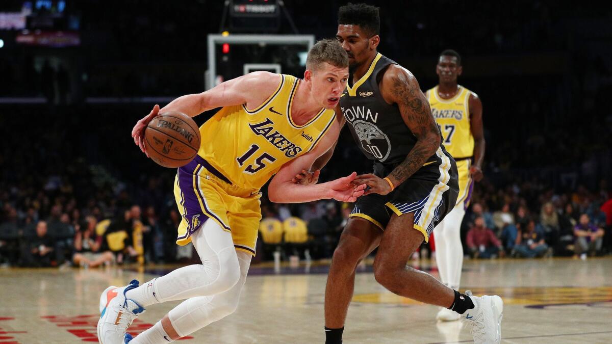 Lakers' Moritz Wagner, left, drives against Golden State Warriors' Jacob Evans during the second half at Staples Center on Thursday.