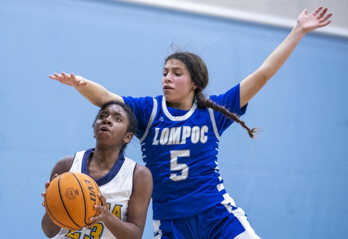 Marina's Rylee Bradley takes a shot under pressure from Lompoc's Tara Terrones on Tuesday.