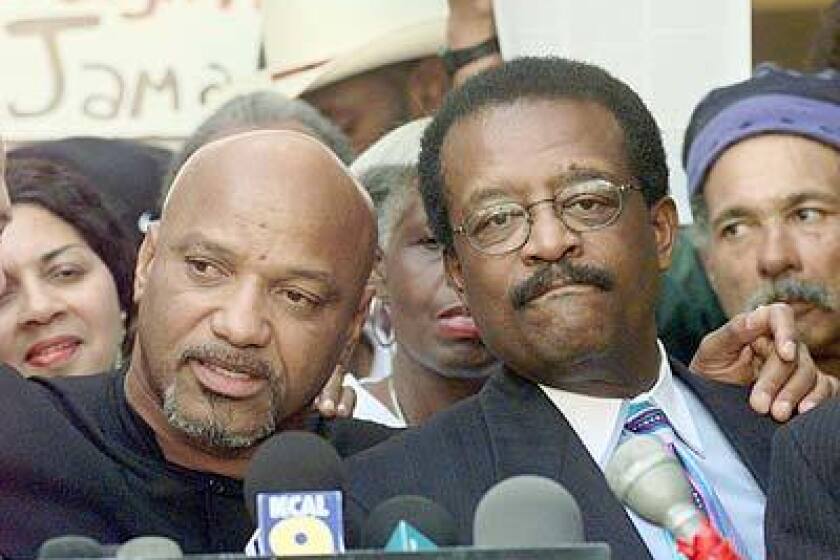 Former Black Panther Elmer "Geronimo" Pratt, left, is joined by attorney Johnnie Cochran during a sidewalk news conference outside the Second District Court of Appeals in Los Angeles.