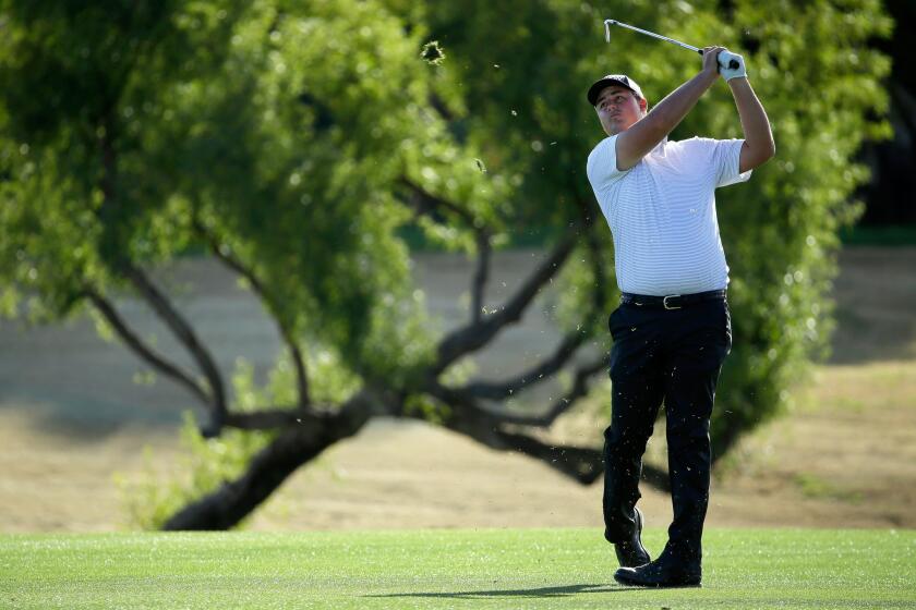 Michael Putnam takes his second shot on the 18th hole during the first round of the Humana Challenge in La Quinta.