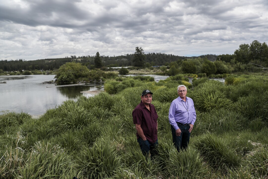 Clayton Dumont, left, and tribal Chairman Don Gentry stand next to the Sprague River 