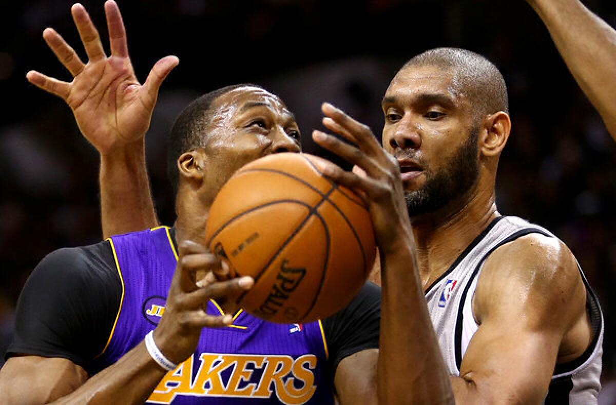 Lakers center Dwight Howard tries to power his way past Spurs power forward Tim Duncan during Game 2 of their best-of-seven playoff series Wednesday night in San Antonio.