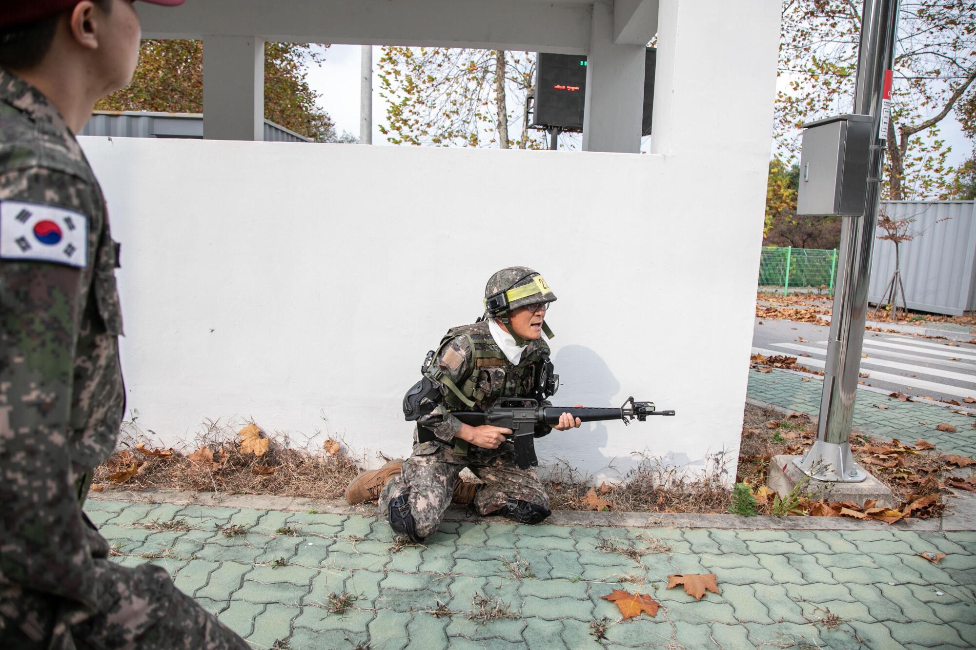 A member of the Senior Army participates in a mock urban warfare during military training at the