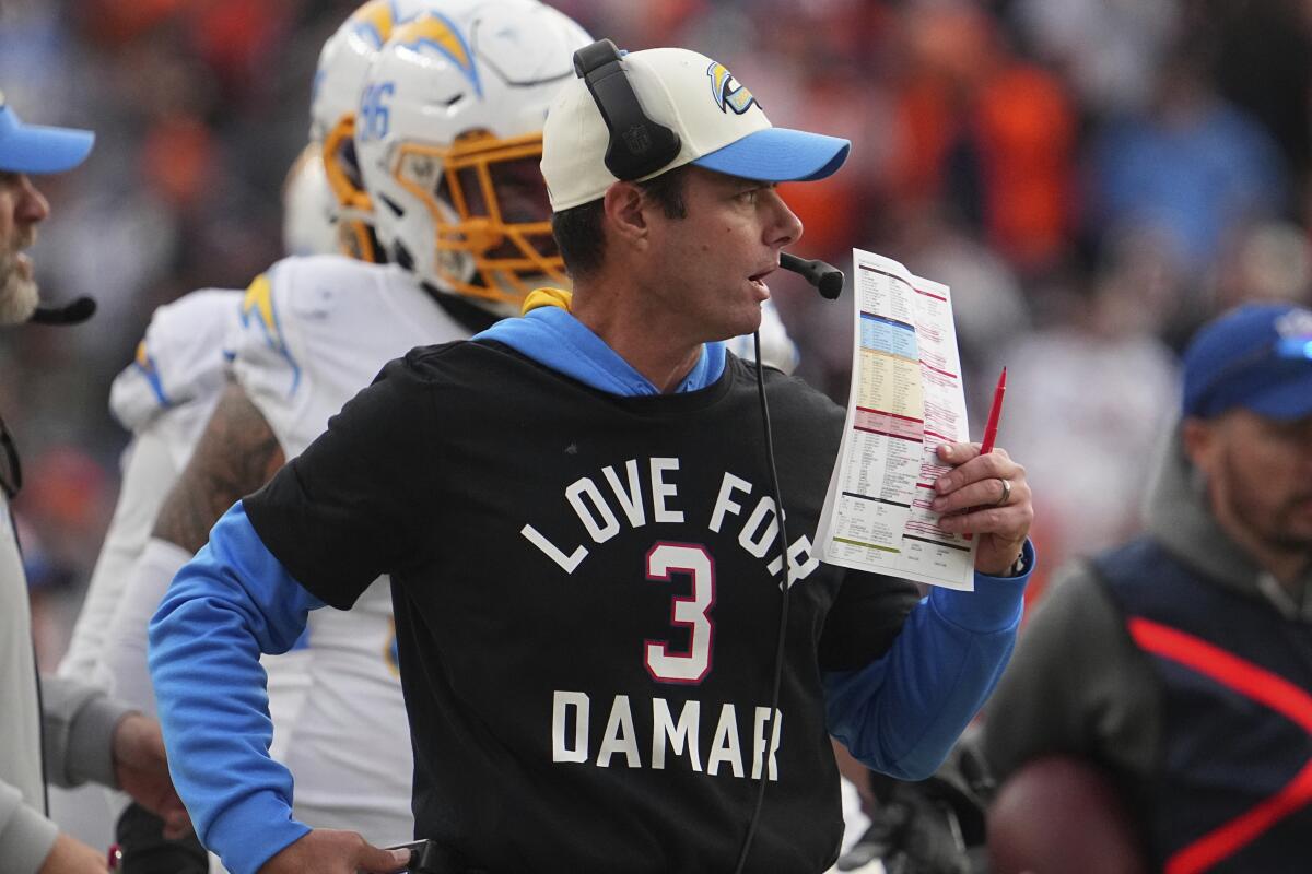 Chargers coach Brandon Staley stands on the sideline during a loss to the Denver Broncos on Jan. 8.
