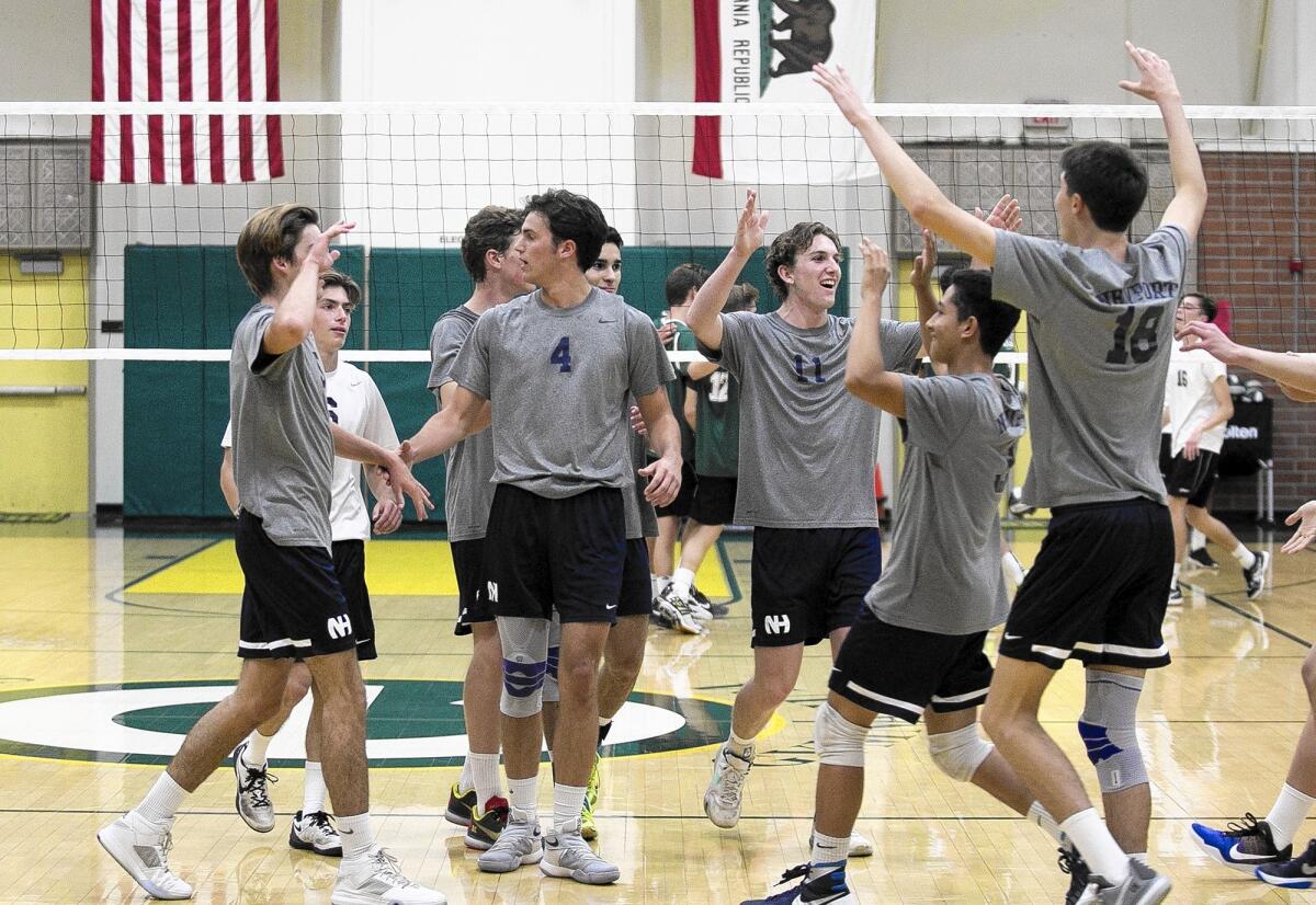 The Newport Harbor High boys' volleyball team celebrates a sweep over Edison in a Sunset League match at Edison on Tuesday.