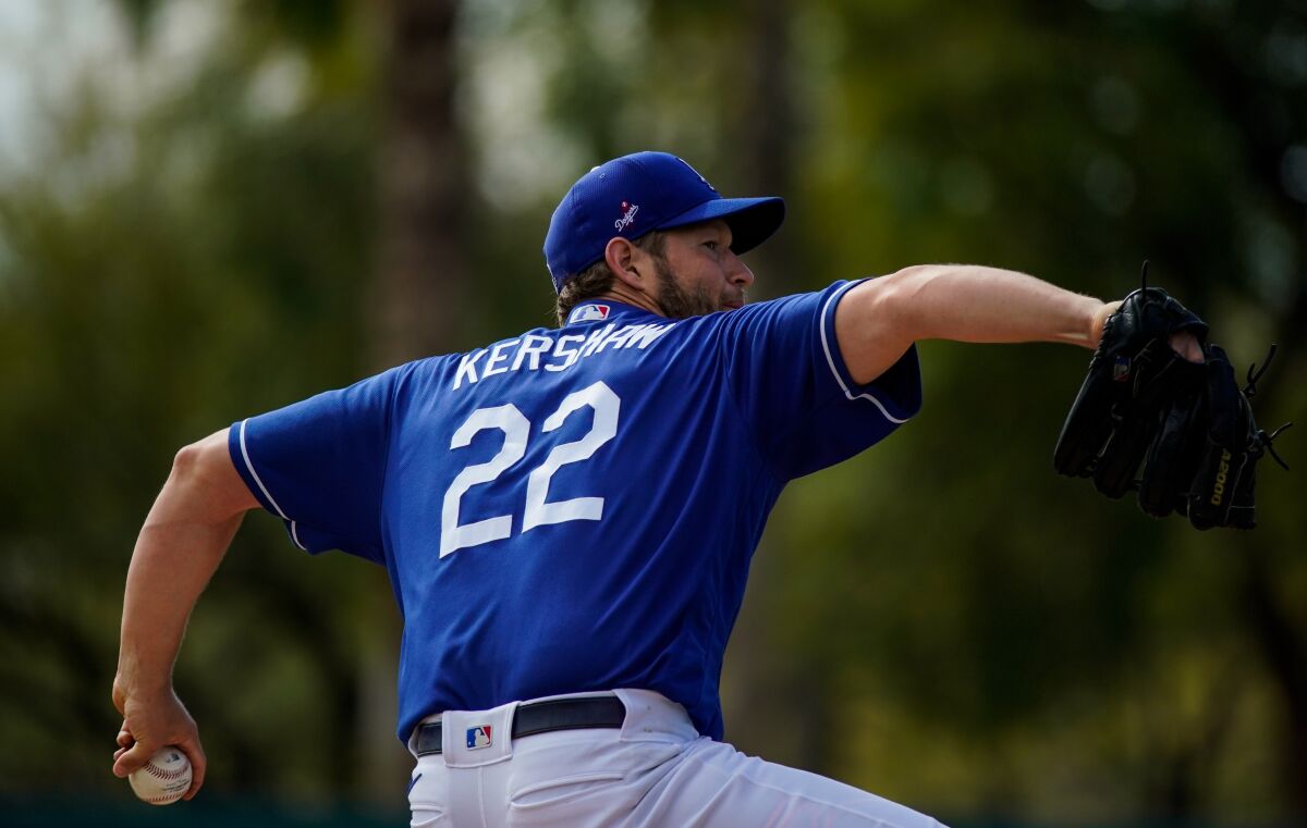 Dodgers pitcher Clayton Kershaw delivers during live batting practice before a spring training game against the Chicago Cubs on Sunday.
