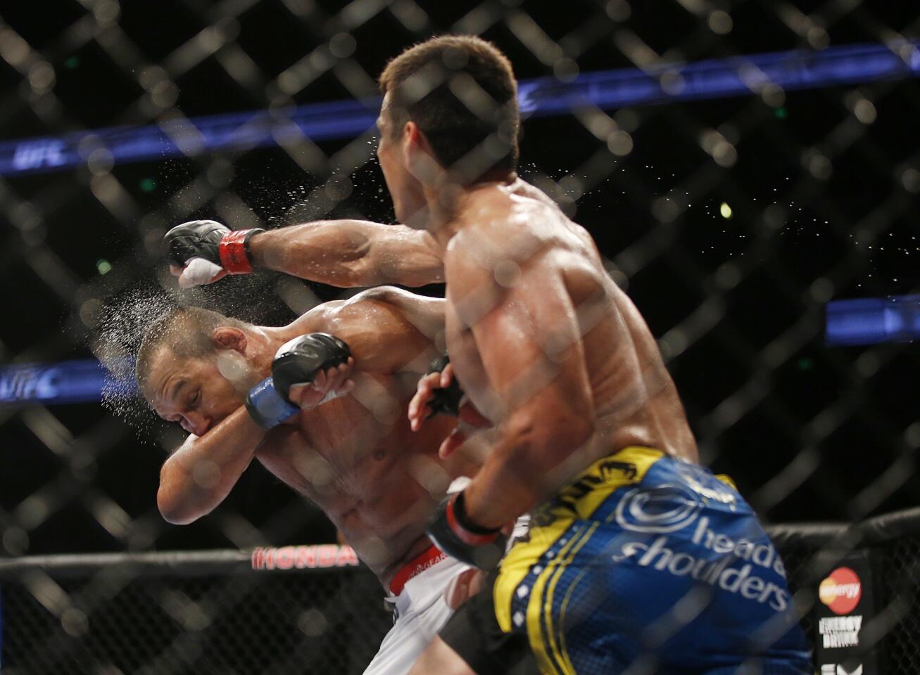 Lyoto Machida lands a punch against Dan Henderson during their light-heavyweight fight at UFC 157 on Saturday night at the Honda Center in Anaheim.