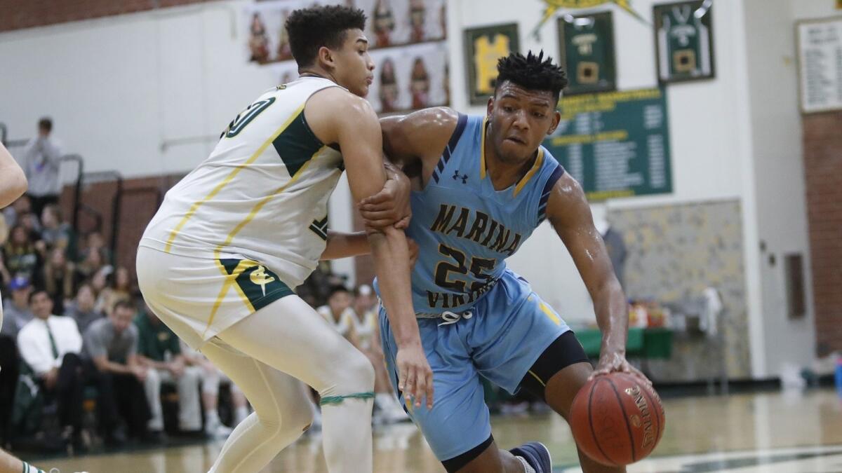Marina High's Jakob Alamudun, pictured driving to the basket against Edison's Josh Phillips on Jan. 5, led the Vikings to a 70-53 win over Sunny Hills on Thursday.