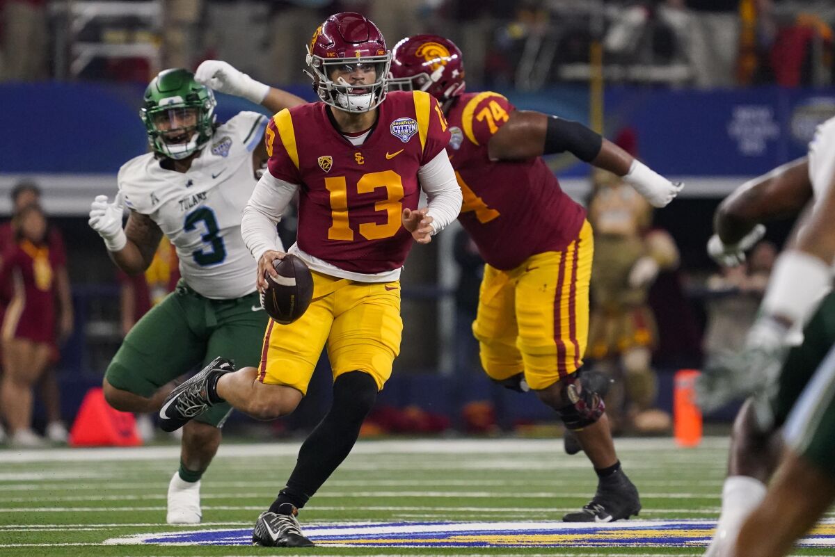 USC quarterback Caleb Williams scrambles with the ball against Tulane in the first half.
