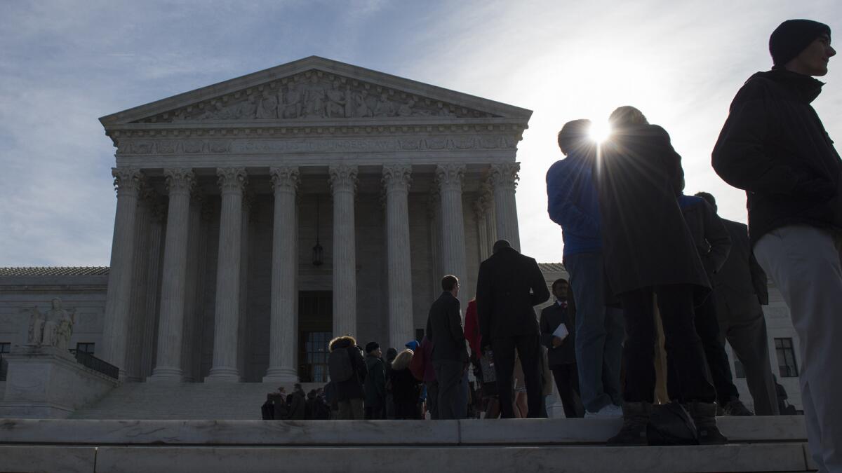 People wait in line outside the Supreme Court in Washington in hopes of admittance for oral arguments.