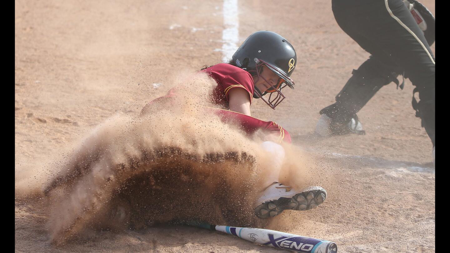 Ocean View High's Caitlyn Sideris slides safely into home in a softball game against Segerstrom on Friday.