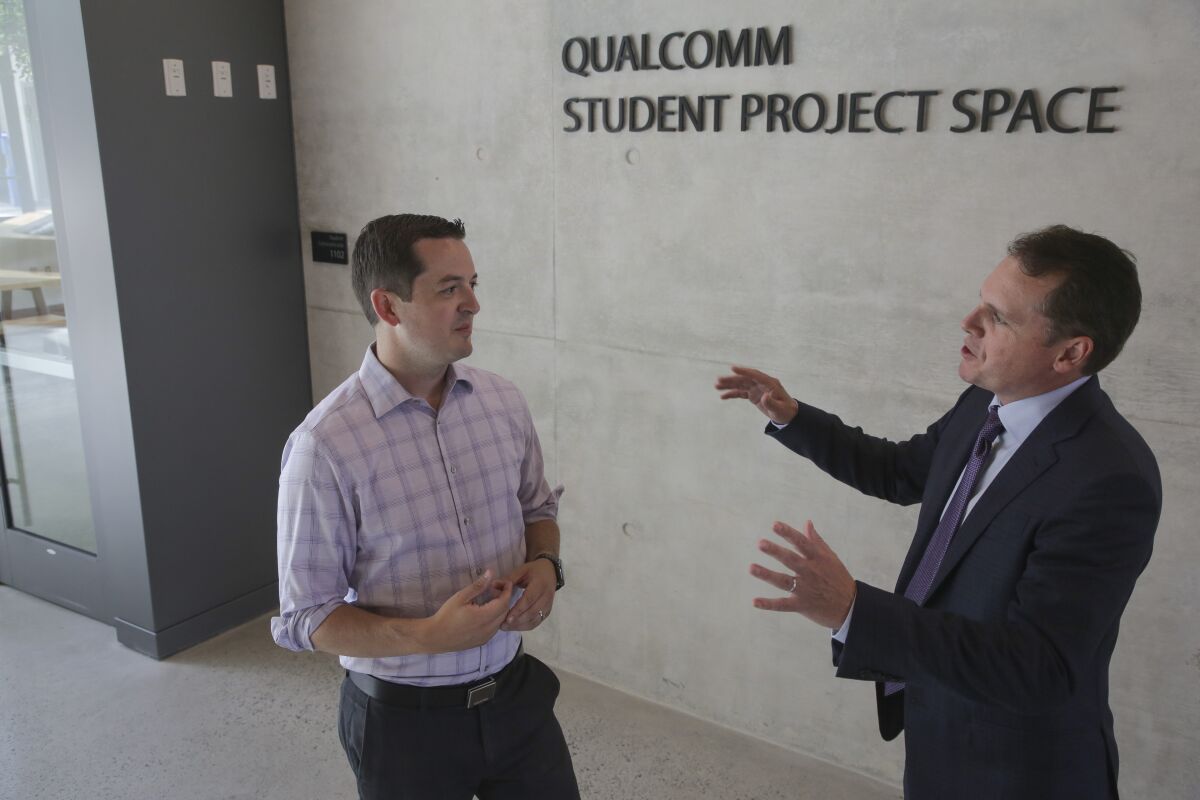 UC San Diego professor Patrick Mercier (left) talks with Qualcomm executive John Smee in Franklin Antonio Hall.