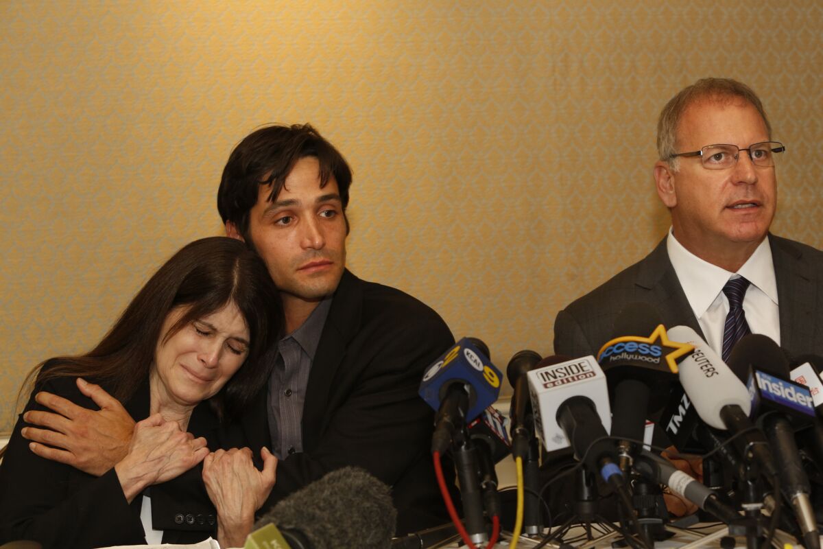 Michael Egan, center, his attorney Jeff Herman, right, and Egan's mother, Bonnie Mound, at a news conference in April.