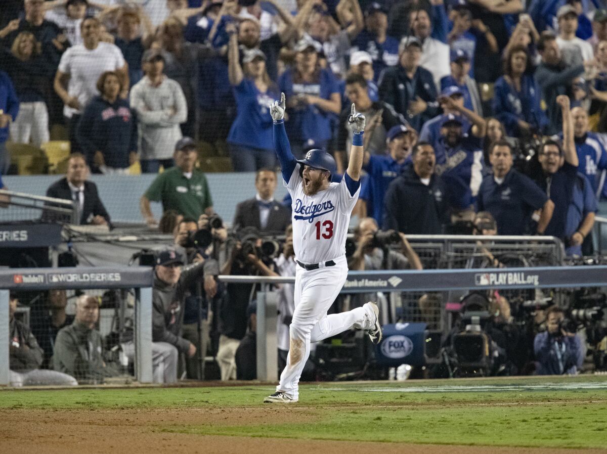 Max Muncy celebrates after hitting the game-winning home run and leading the Dodgers to defeat the Boston Red Sox in Game 3 of the World Series.