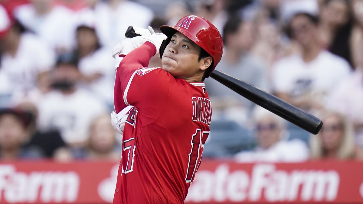 Los Angeles Angels' Shohei Ohtani watches his hit during the first inning.