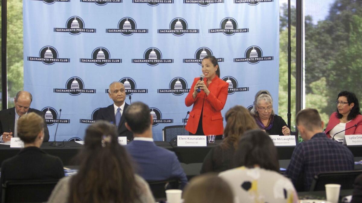 Democrat Eleni Kounalakis, standing, speaks during a lieutenant governor's race debate April 17. Also there are candidates Jeff Bleich, left, Ed Hernandez, Gayle McLaughlin and Lydia Ortega.