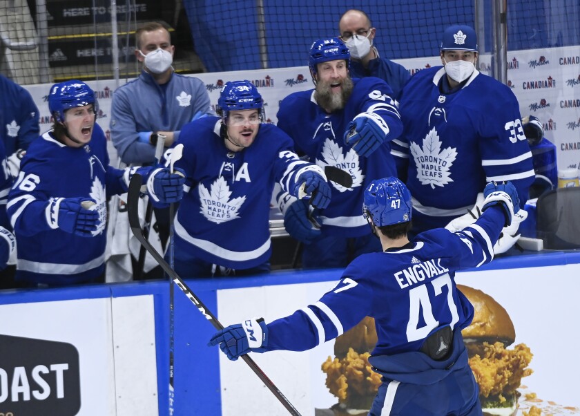 Toronto Maple Leafs forward Pierre Engvall (47) celebrates his goal against the Montreal Canadiens with Mitchell Marner (16), Auston Matthews (34), Joe Thornton (97) and David Rittich (33) during the second period of an NHL hockey game Saturday, May 8, 2021, in Toronto. (Nathan Denette/The Canadian Press via AP)