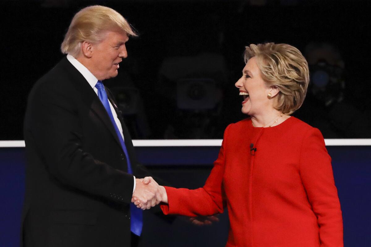Republican presidential nominee Donald Trump shakes hands with Democratic presidential nominee Hillary Clinton after the presidential debate at Hofstra University.