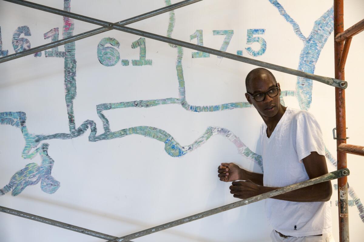 Los Angeles-born artist Mark Bradford, in front of his "Finding Barry, 2015," at the Hammer Museum in Westwood.