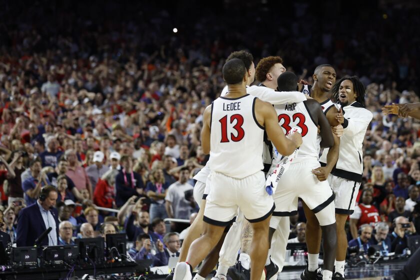 Houston, TX - April 1: San Diego State's Lamont Butler (5) celebrates with teammates after making the game-winning shot to to beat Florida Atlantic 72-71 in a Final Four game in the NCAA Tournament on Saturday, April 1, 2023 in Houston, TX. (K.C. Alfred / The San Diego Union-Tribune)