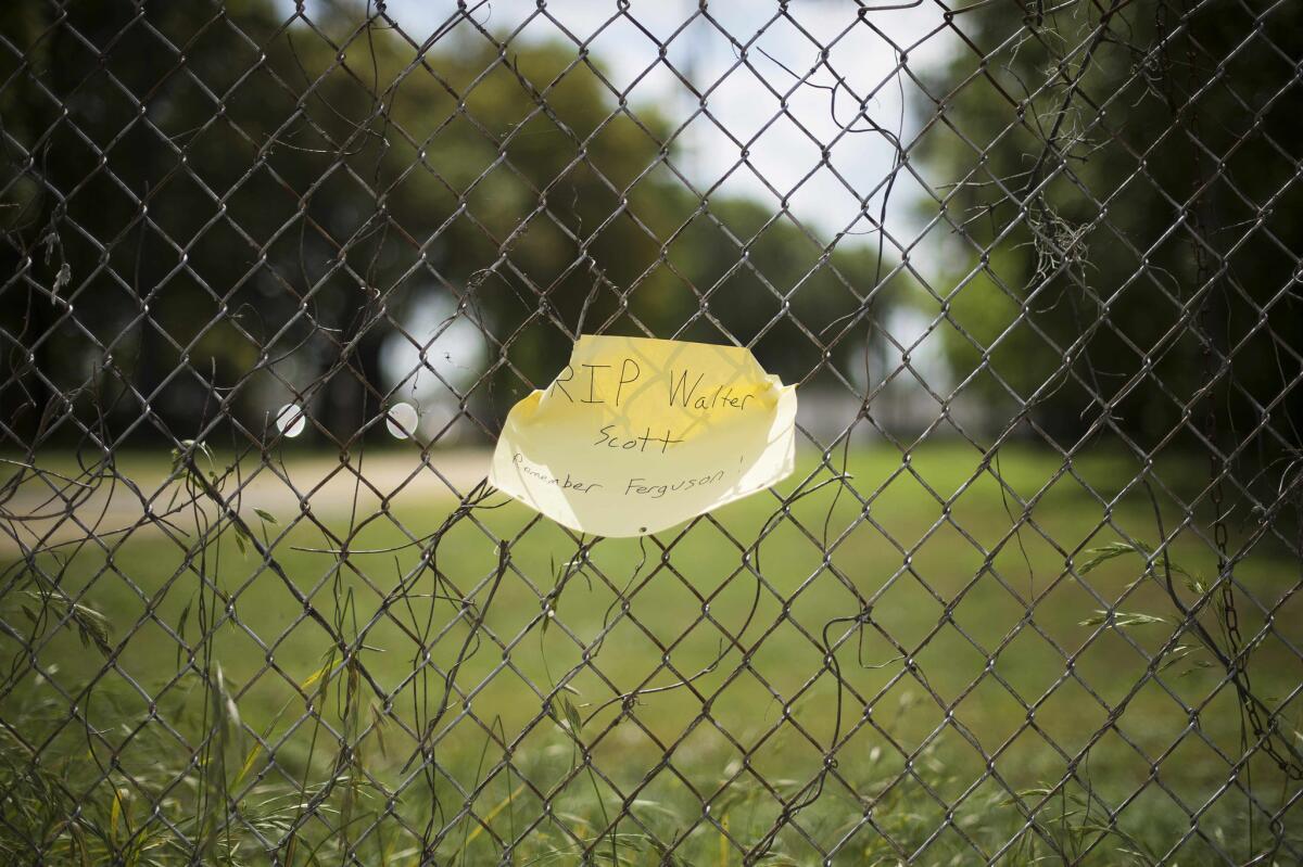 A note is tied to a fence near where Walter Scott, 50, was killed.