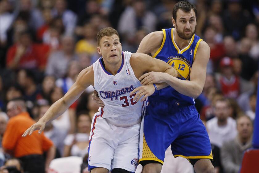 Clippers power forward Blake Griffin, left, battles for position with Golden State Warriors center Andrew Bogut during the first half of Wednesday's game at Staples Center.