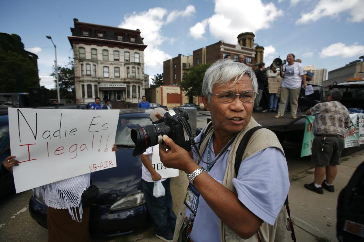 New York Times photographer Dith Pran on assignment in 2006 in Newark, N.J.