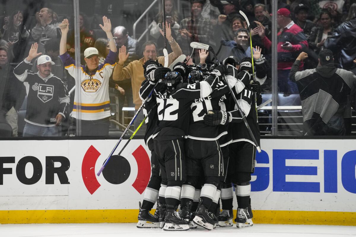 Kings players celebrate and spectators cheer in the stands.