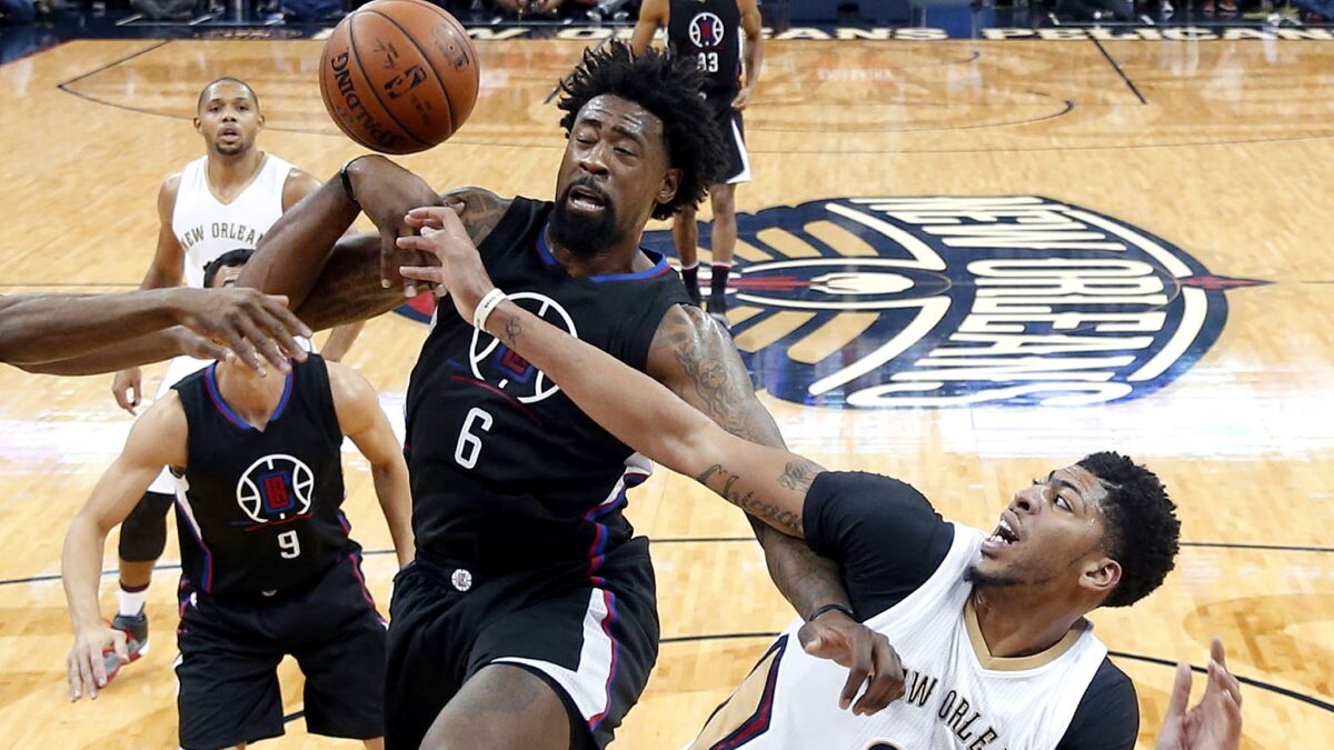Clippers center DeAndre Jordan (6) and Pelicans forward Anthony Davis (23) battle for a rebound during the first half Thursday in New Orleans.
