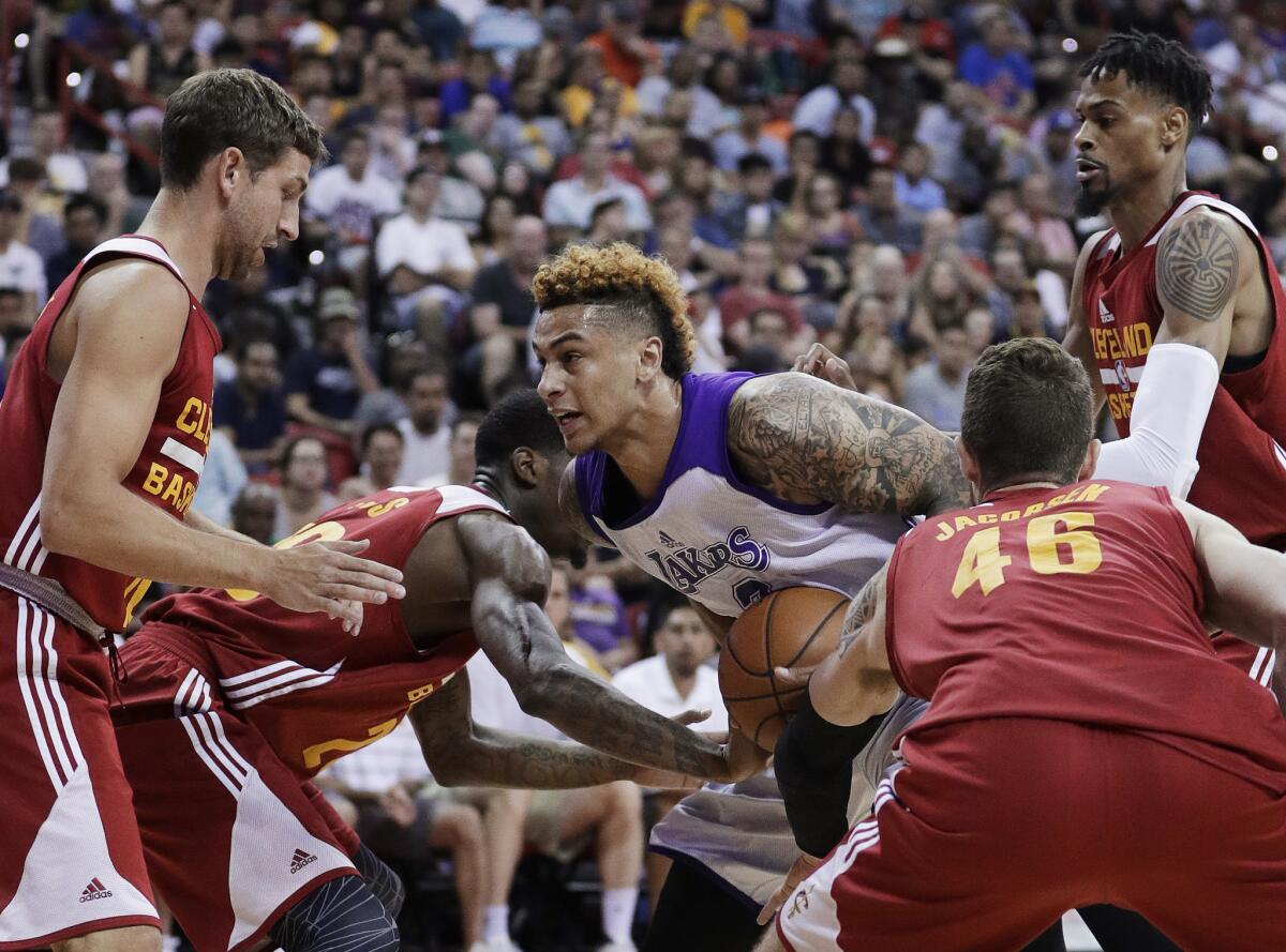 Lakers' Zach Auguste tries to protect the ball from Cleveland's Michael Stockton, left, DeAndre Liggins, Eric Jacobsen and Raphiael Putney.