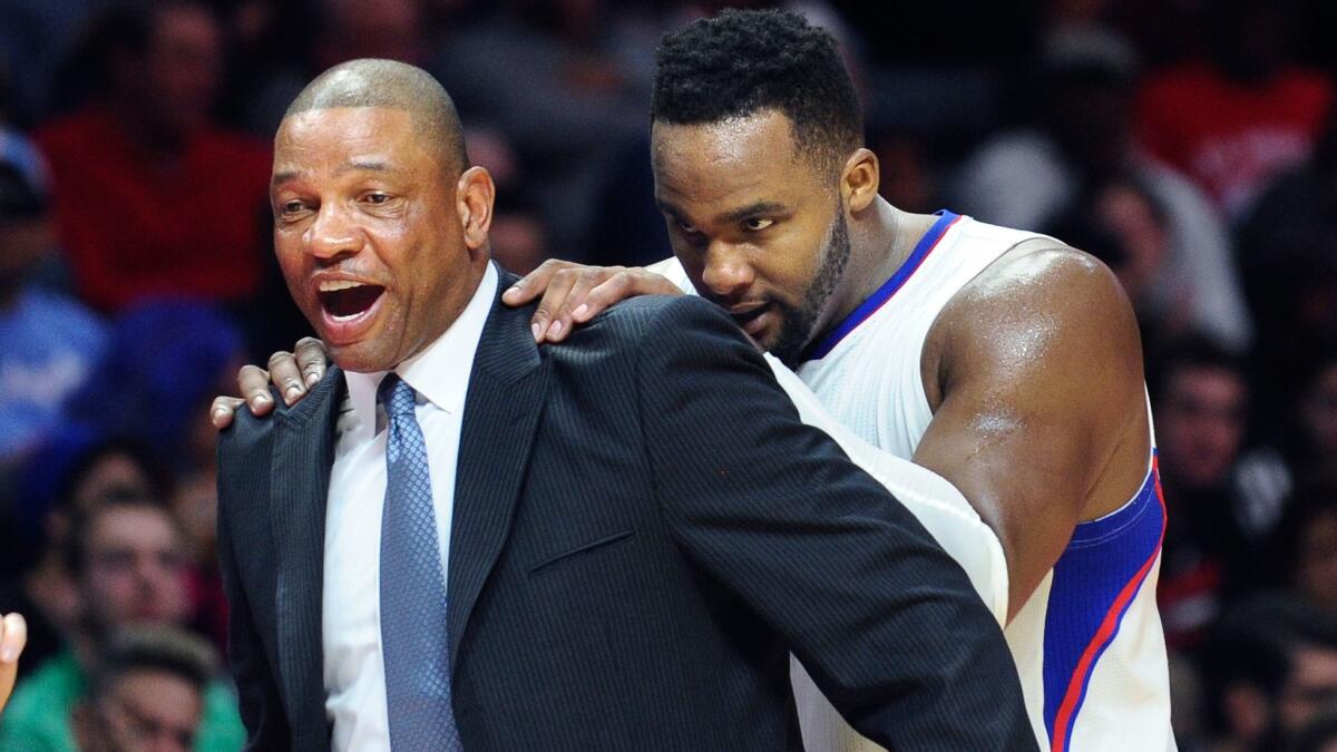 Clippers' Glen Davis, right, goofs around with Coach Doc Rivers on Feb. 21, 2015.