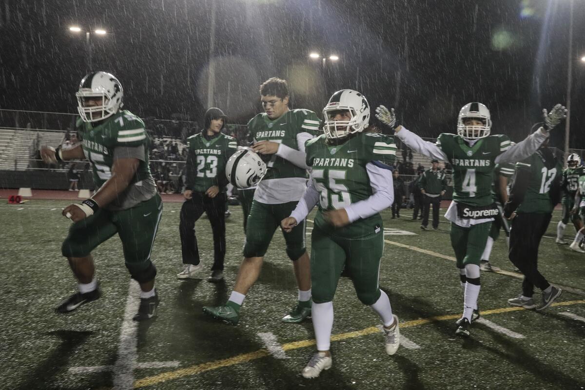South Torrance players celebrate their 47-28 win over Canoga Park on Dec. 6, 2019.