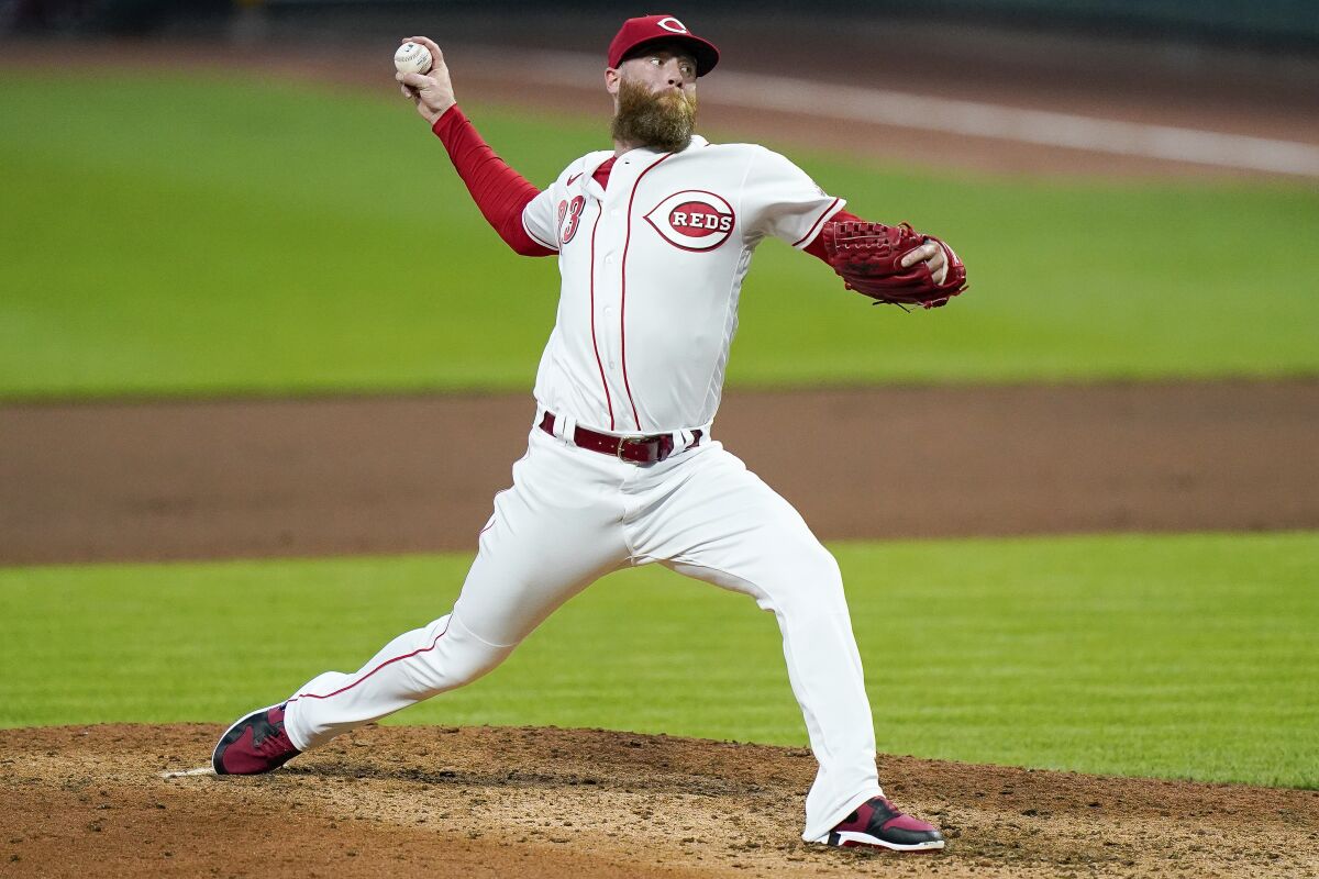 Cincinnati Reds pitcher Archie Bradley throws during the fourth inning of the team's baseball game against the St. Louis Cardinals in Cincinnati, Tuesday, Sept. 1, 2020. (AP Photo/Bryan Woolston)