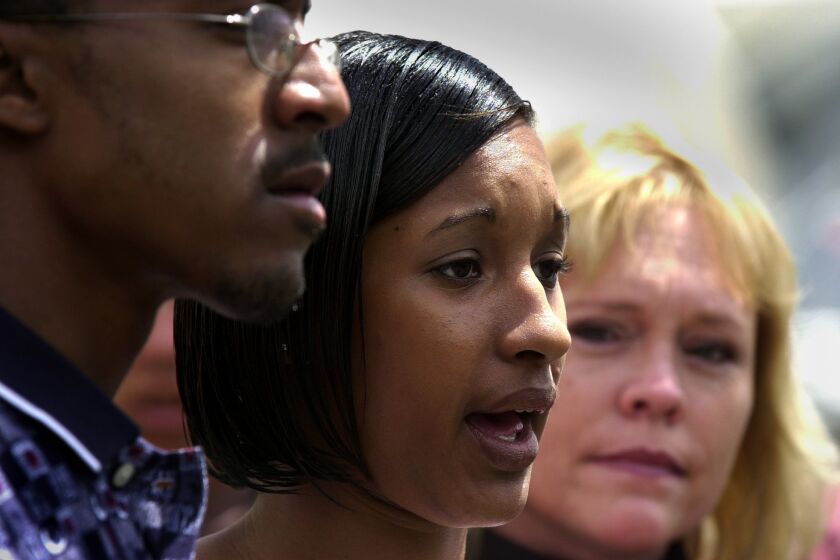 Jahi Turner's stepfather Tieray Jones, 23, left, and mother Tameka Jones, 18, and Brenda van Dam at a press conference in Golden Hill near the park where Jahi disappeared.--UT photo/Laura Embry April 30, 2002