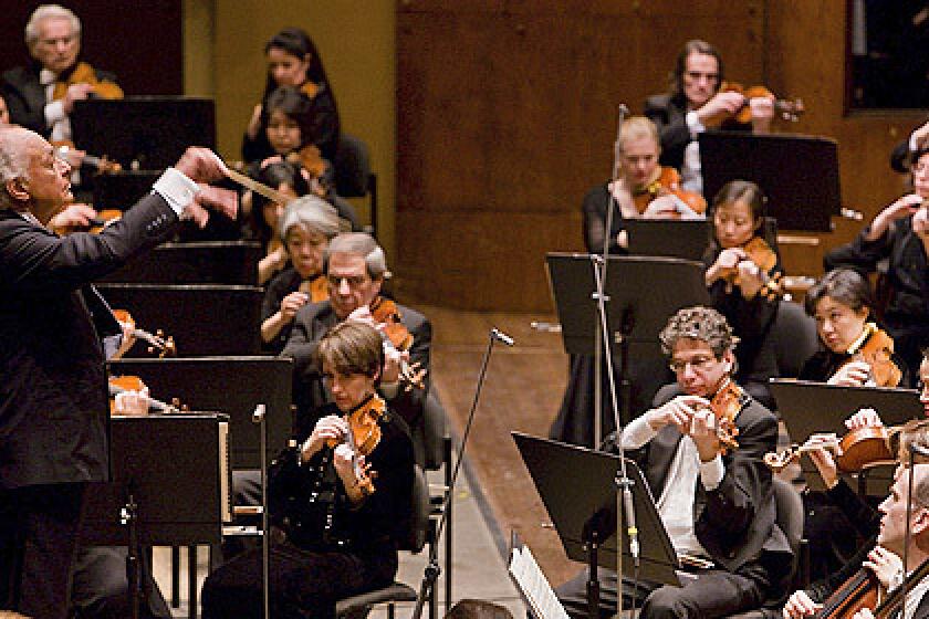In this photo released by the New York Philharmonic, Lorin Maazel, left, conducts the orchestra at Avery Fisher Hall on Jan. 30, 2008.