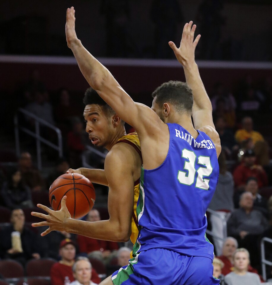 LOS ANGELES, CALIF. - DEC. 29, 2019. USC forward Isaiah Mobley works the ball inside against FGCU center Justus Rainwater in the second half Sunday night, Dec. 29, 2019, at Galen Center in Los Angeles. (Luis Sinco/Los Angeles Times)