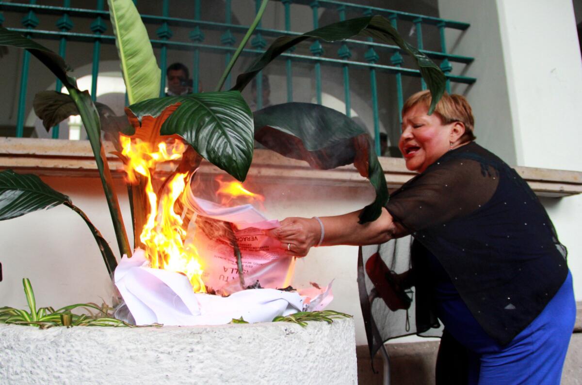 A woman burns electoral material in Veracruz, Mexico, on June 5, 2016.
