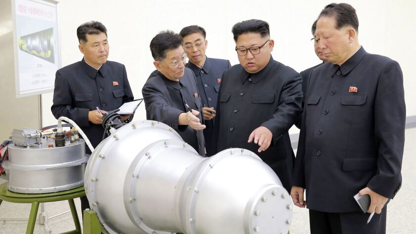North Korean leader Kim Jong Un views a device in an undated photo released by the state news agency.