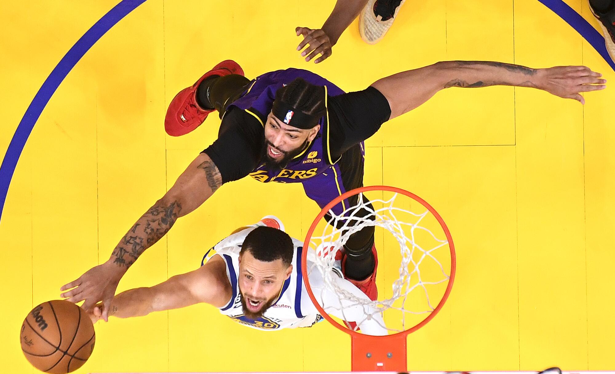 Lakers Anthony Davis blocks the shot of Warriors Stephen Curry in the third quarter.