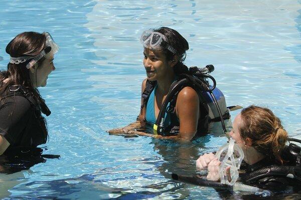 Maya Davies, 13 of Pasadena, left, and Nayelli Rojas, center, 13 of La Habra, come up after their first-ever scuba dive with instructor Lisa Jover, right, during a free, women-only introductory scuba lesson at Sport Chalet in La Canada Flintridge on Saturday, August 17, 2013.