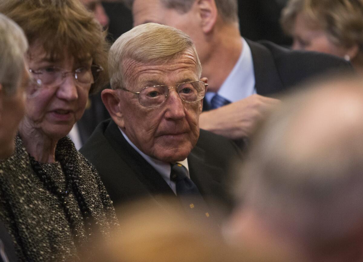 Lou Holtz takes his seat before the March 4 funeral service for Rev. Theodore Hesburgh at the University of Notre Dame in South Bend, Ind.