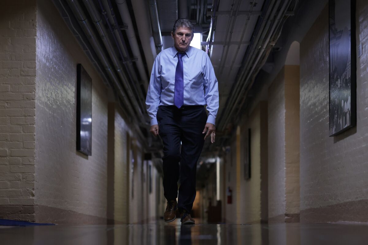 Sen. Joe Manchin III walks through a hallway in the basement of the U.S. Capitol on Dec. 15. 
