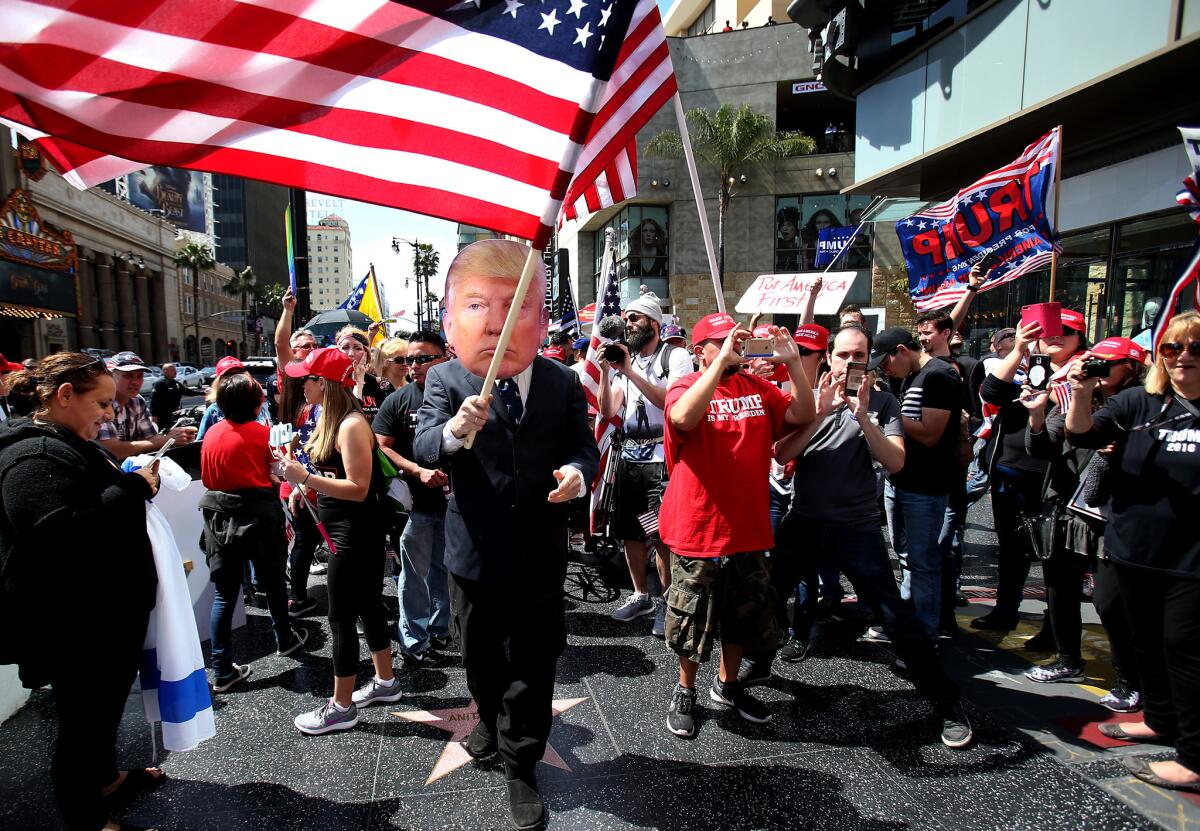 Supporters of President Trump march in a Make America Great Again rally on Hollywood Boulevard.