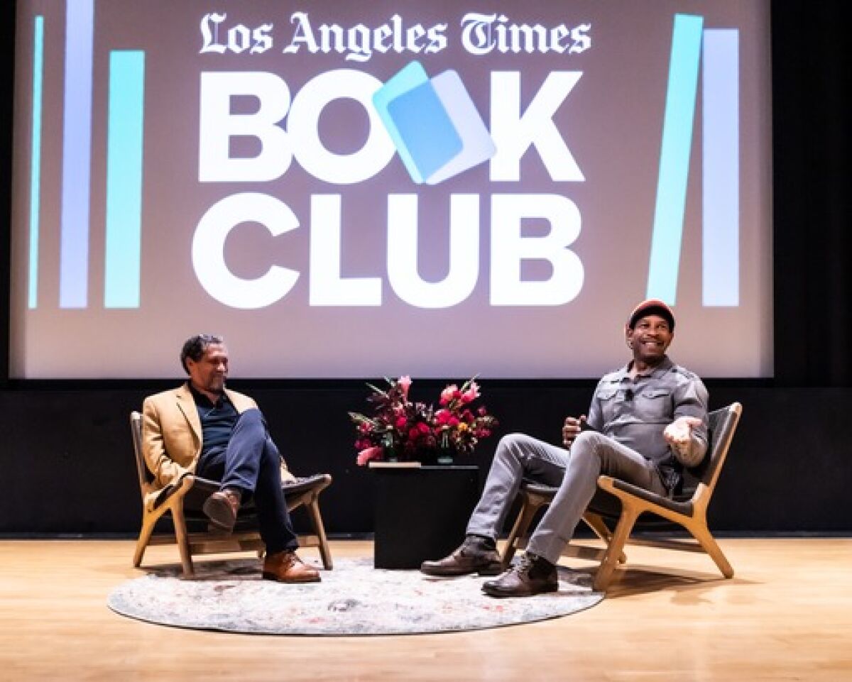 Two men seated onstage in front of a screen that says Los Angeles Times Book Club